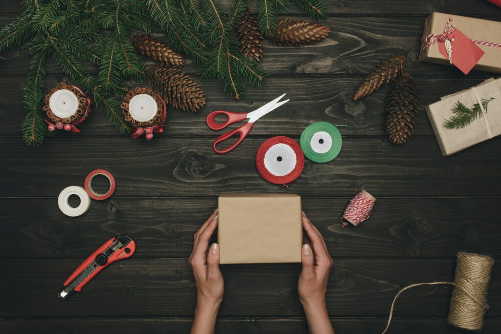 top view of woman decorating christmas gift